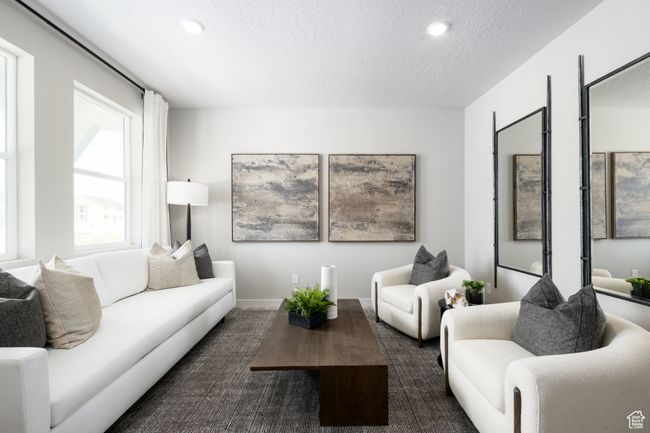 Living area with a textured ceiling, recessed lighting, and baseboards | Image 10
