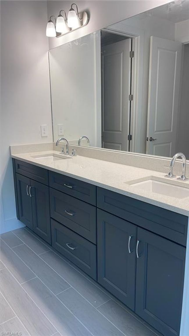 Primary bathroom dual-sinks with lovely quartz countertops and soft-close cabinets and drawers | Image 18