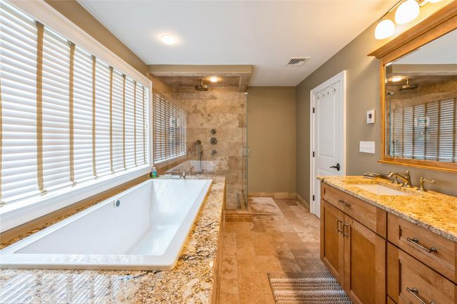 Primary Bathroom with a stall shower, vanity, and a garden tub | Image 15