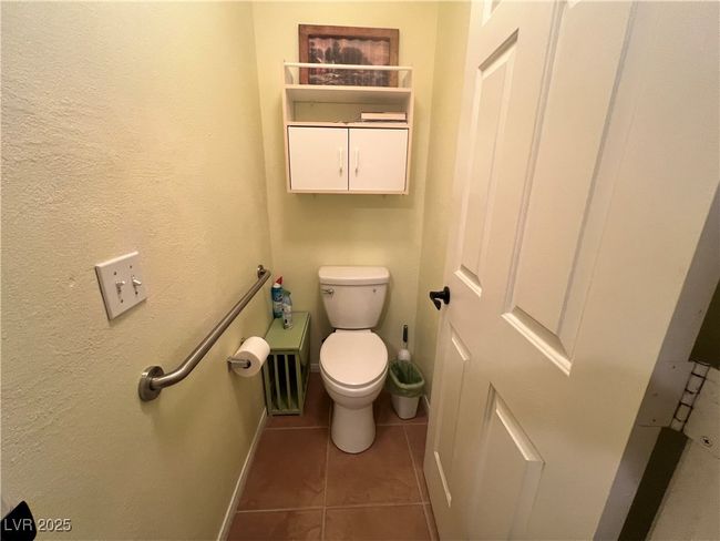 Bathroom in laundry room tile patterned flooring and toilet | Image 25