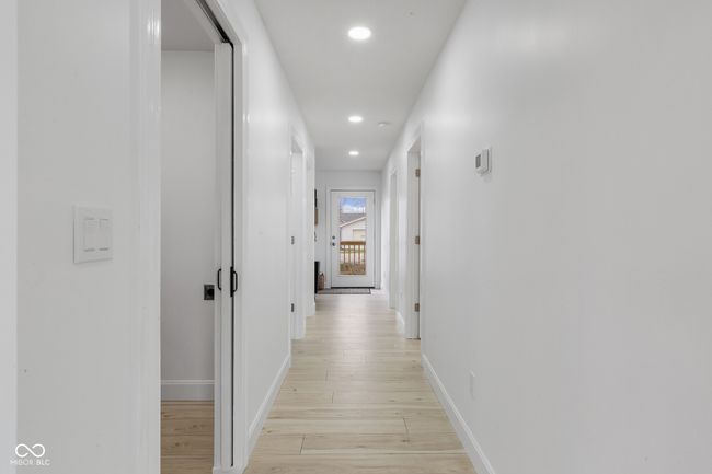 hallway with baseboards, recessed lighting, and light wood-style floors | Image 35