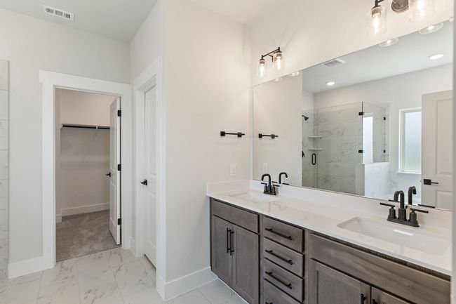Bathroom with marble finish floors, a stall shower, a spacious closet, and double vanity | Image 13
