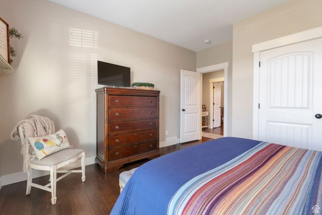 Bedroom with a closet, baseboards, and dark wood finished floors | Image 32