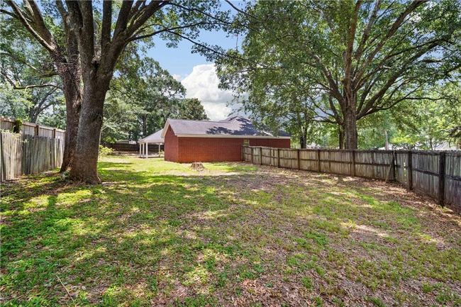 View of fenced backyard | Image 29
