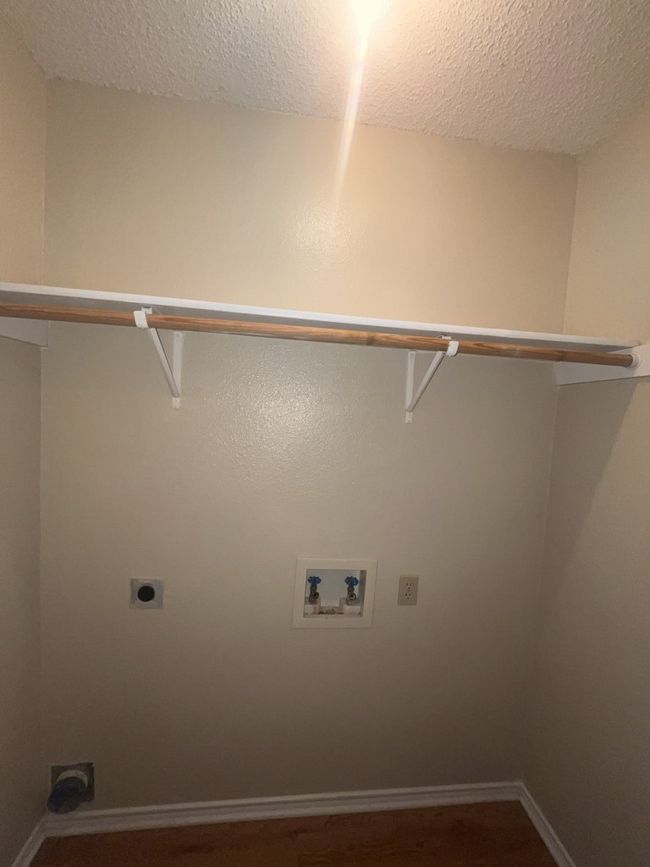 Clothes washing area featuring washer hookup, a textured ceiling, electric dryer hookup, laundry area, and baseboards | Image 9