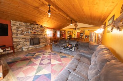 Vaulted ceilings, natural stone fireplace, sliders to patio | Image 2