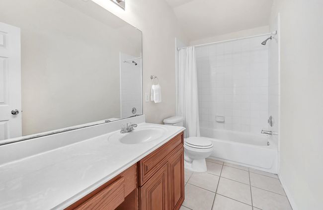 Centrally located secondary bath with vanity area and shower/tub combo. | Image 26