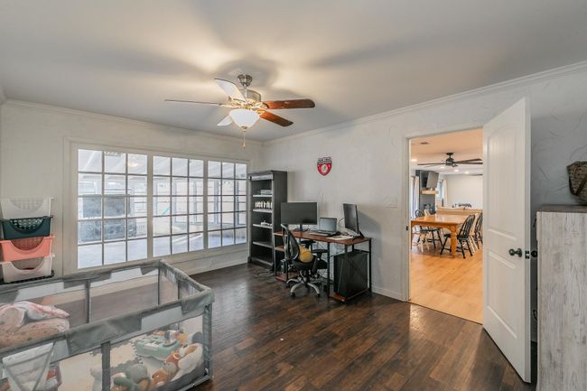Home office with a ceiling fan, wood finished floors, and ornamental molding | Image 13