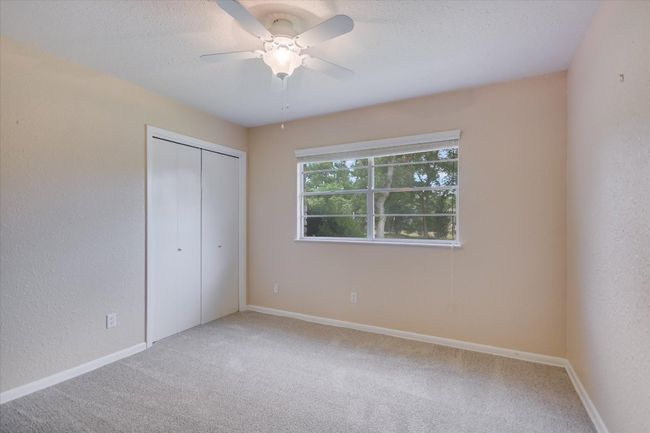 Another secondary bedroom with a ceiling fan & carpet installed in May 2025. | Image 27