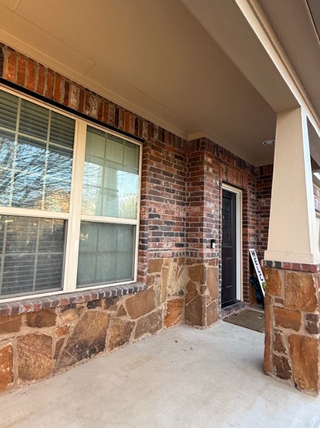 Entrance to property featuring brick siding, and patio. | Image 9