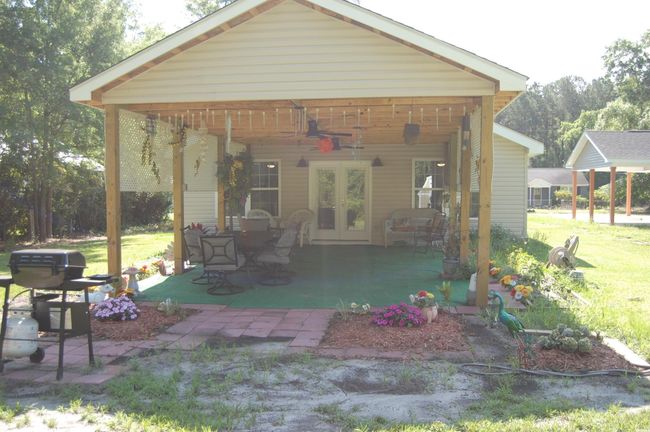 Rear view of property with ceiling fan, a lawn, french doors, and a patio | Image 22