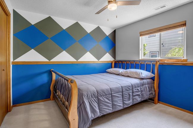 Carpeted bedroom featuring a textured ceiling, ceiling fan, and baseboards | Image 29