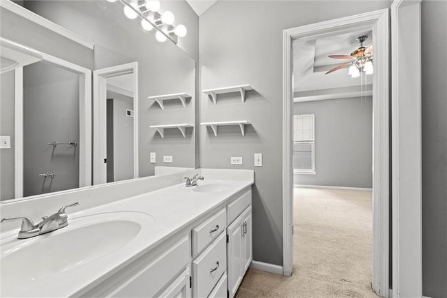 Bathroom with double vanity and a ceiling fan | Image 21