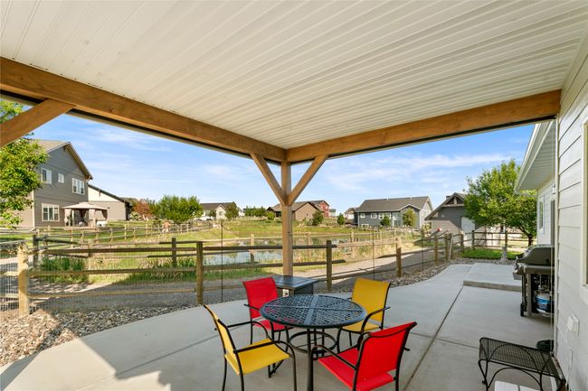Fenced backyard with a patio, a residential view, grilling area, and outdoor dining space | Image 27
