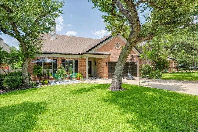 View of front of property featuring brick siding, driveway, an attached garage, a front yard, and a chimney | Image 39