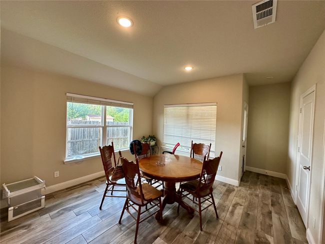 Dining space with wood finished floors, recessed lighting, and vaulted ceiling | Image 14