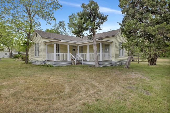 Bungalow-style home featuring roof with shingles, a porch, and a front lawn | Image 23