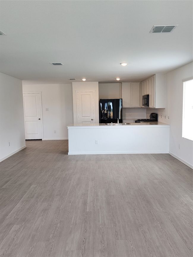Unfurnished living room featuring light wood-style floors and recessed lighting | Image 4