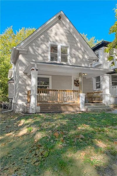 View of front facade featuring a porch and a front yard | Image 2