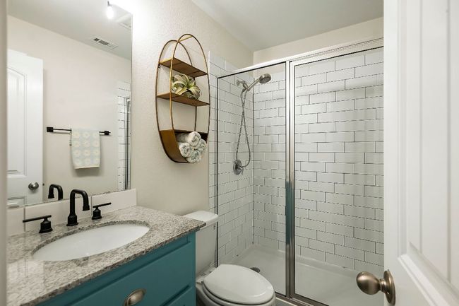 The full guest bathroom features modern fixtures and is conveniently located near the secondary bedrooms. | Image 21