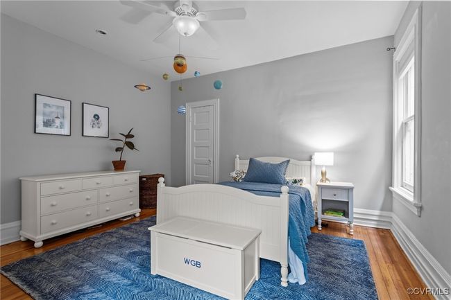 Bedroom with wood finished floors, baseboards, and ceiling fan | Image 24