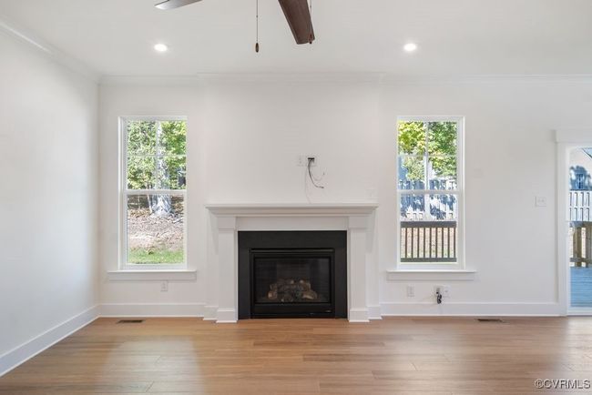 Photo represents the plan, not the actual home. Design selections may vary. A spacious kitchen with an island and pantry open to an adjoining dining area and the family room. | Image 18