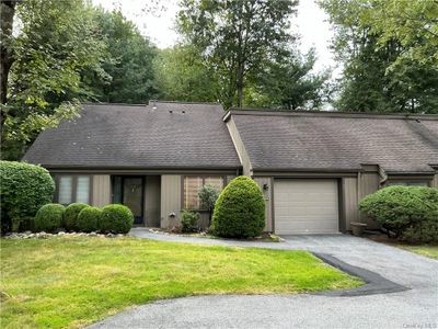 View of front of house featuring a garage and a front lawn | Image 1