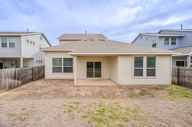 Rear view of house featuring a fenced backyard, a patio area, and roof with shingles | Image 34