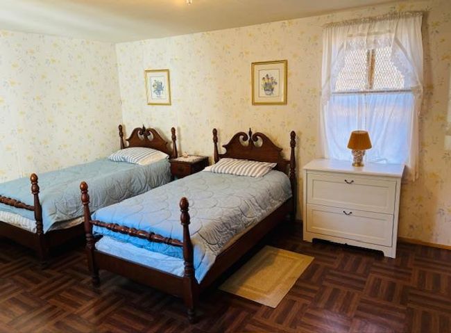 Bedroom featuring dark parquet flooring | Image 12