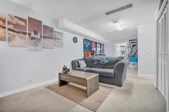 Living area featuring visible vents, baseboards, and carpet flooring | Image 26