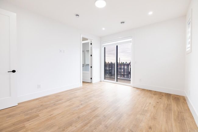 Empty room with light wood-style flooring and recessed lighting | Image 28