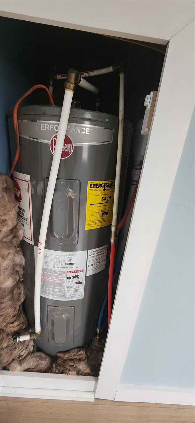 Utility room featuring electric water heater | Image 40