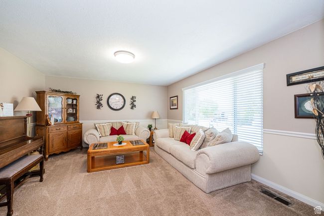Living room featuring visible vents and carpet flooring | Image 12