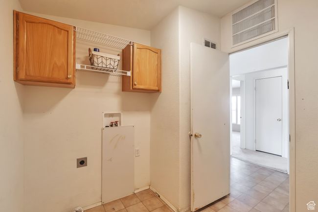 Laundry room featuring washer hookup, hookup for an electric dryer, and cabinet space | Image 20