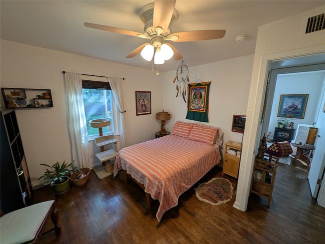 Bedroom featuring wood finished floors, visible vents, and ceiling fan | Image 18