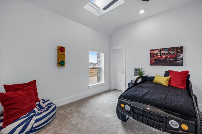 Bedroom featuring light colored carpet and vaulted ceiling with skylight | Image 26