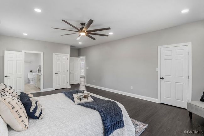 Another view of primary bedroom includes walk-closets | Image 11