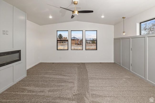 Basement featuring light carpet and ceiling fan | Image 16
