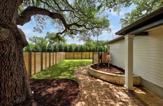 View of yard featuring a fenced backyard and a patio | Image 26