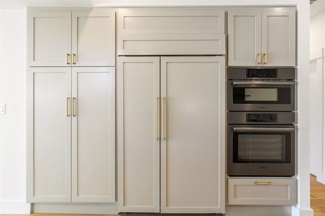 Built in sub zero fridge and cabinet storage | Image 11