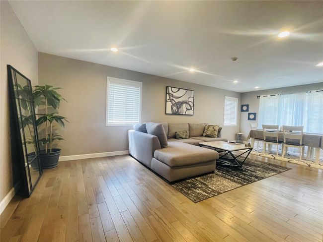 Living area with hardwood / wood-style floors, a healthy amount of sunlight | Image 8