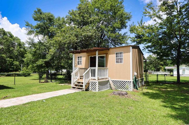 View of front of house featuring a fenced backyard and a gate | Image 26