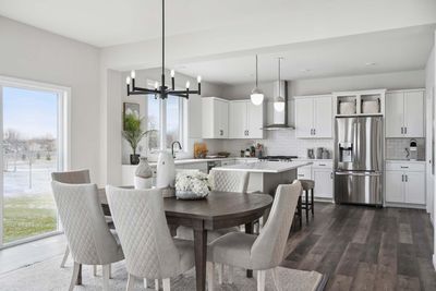 Inspiration photo of previously built model. Options, &features may vary. So open & airy, the kitchen truly is the heart of the home. It offers ample space for both entertaining &everyday life, making it a central gathering place for family & friends | Image 2