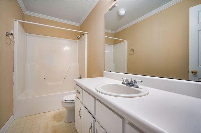 Full bath with vanity, crown molding, shower combination, and tile patterned floors | Image 22