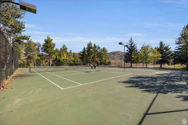 View of tennis court with fence | Image 23