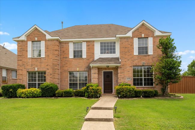 View of front of house featuring brick siding and a shingled roof | Image 5