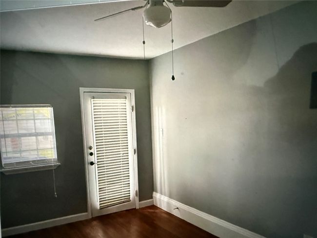 Office or flex space with separate entrance. With ceiling fan and dark wood-style floors | Image 17