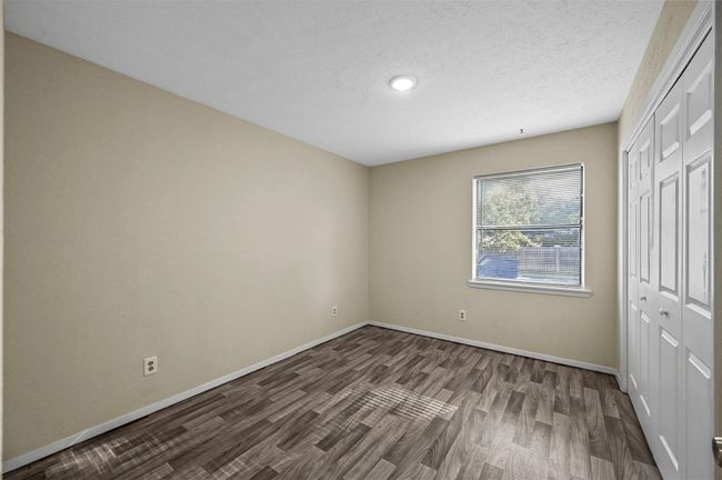 Unfurnished bedroom featuring a closet, wood finished floors, and recessed lighting | Image 8