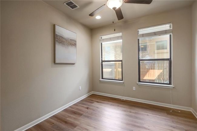 Unfurnished room featuring ceiling fan and wood finished floors | Image 21
