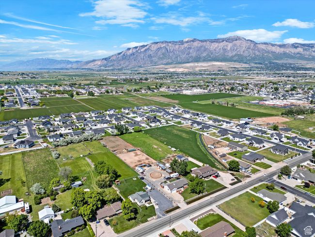 Aerial view of property's location with a mountain backdrop and nearby suburban area | Image 54